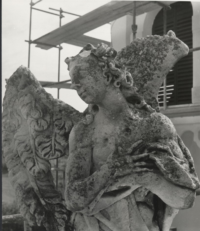 The sculpture of angel from the left side of the façade (source of the photo: Regional Archive Maribor; photo by Bogdan Badovinac, 1990)
